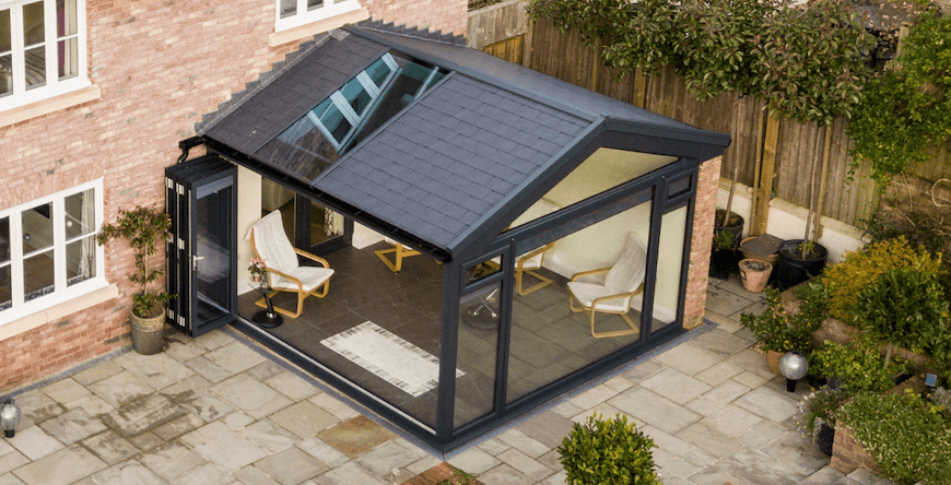 Black tiled conservatory roof with a roof window and bifold doors